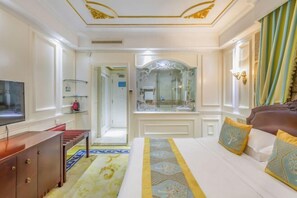A hotel room with a bed, a TV, a dresser, a mirror, and a bathroom door. - Succeed Hotel (Tangshan)