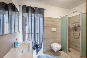 Shower, hair dryer, towels, toilet paper