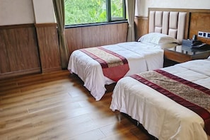 A hotel room with two beds, wooden flooring, a window with curtains, and a wooden headboard. - Qincaige Hostel (Chongqing)