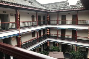 A multi-story building with balconies, railings, and traditional architectural elements. - Qincaige Hostel (Chongqing)
