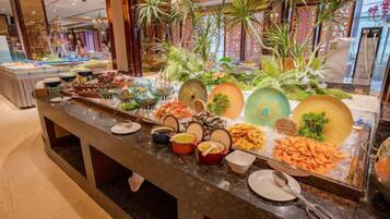 A buffet with various food items and decorative elements.