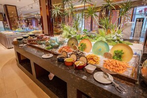 A buffet with various food items and decorative elements. - Baiyun Hotel (West Building) (Lanzhou)