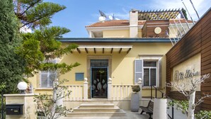 A building with a beige facade, a wooden pergola on the roof, and a sign reading "St. Elena". - Elena Boutique Residence (Larnaca)