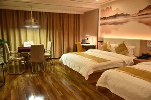 A hotel room with two beds, a desk, chairs, and a large painting on the wall. - Kaisheng Hotel (Xiangtan)
