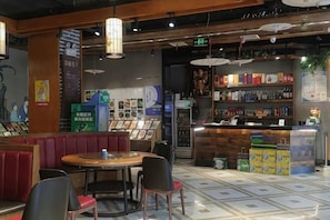 A restaurant interior with booths, a counter, and a display of food items.