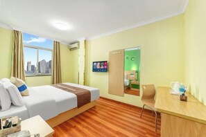A hotel room with a bed, a desk, a chair, and a view of the cityscape through the window. - the 80youth Chain Hotel from Dongguan (Dongguan)