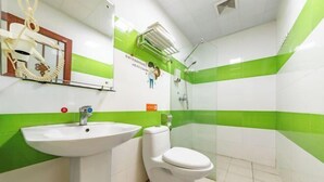 A bathroom with a white sink, toilet, and green-striped walls. - the 80youth Chain Hotel from Dongguan (Dongguan)