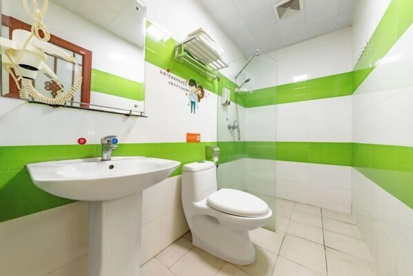 A bathroom with a white sink, toilet, and green-striped walls. - the 80youth Chain Hotel from Dongguan (Dongguan)