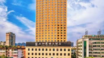 A tall hotel building with a prominent sign at the base.