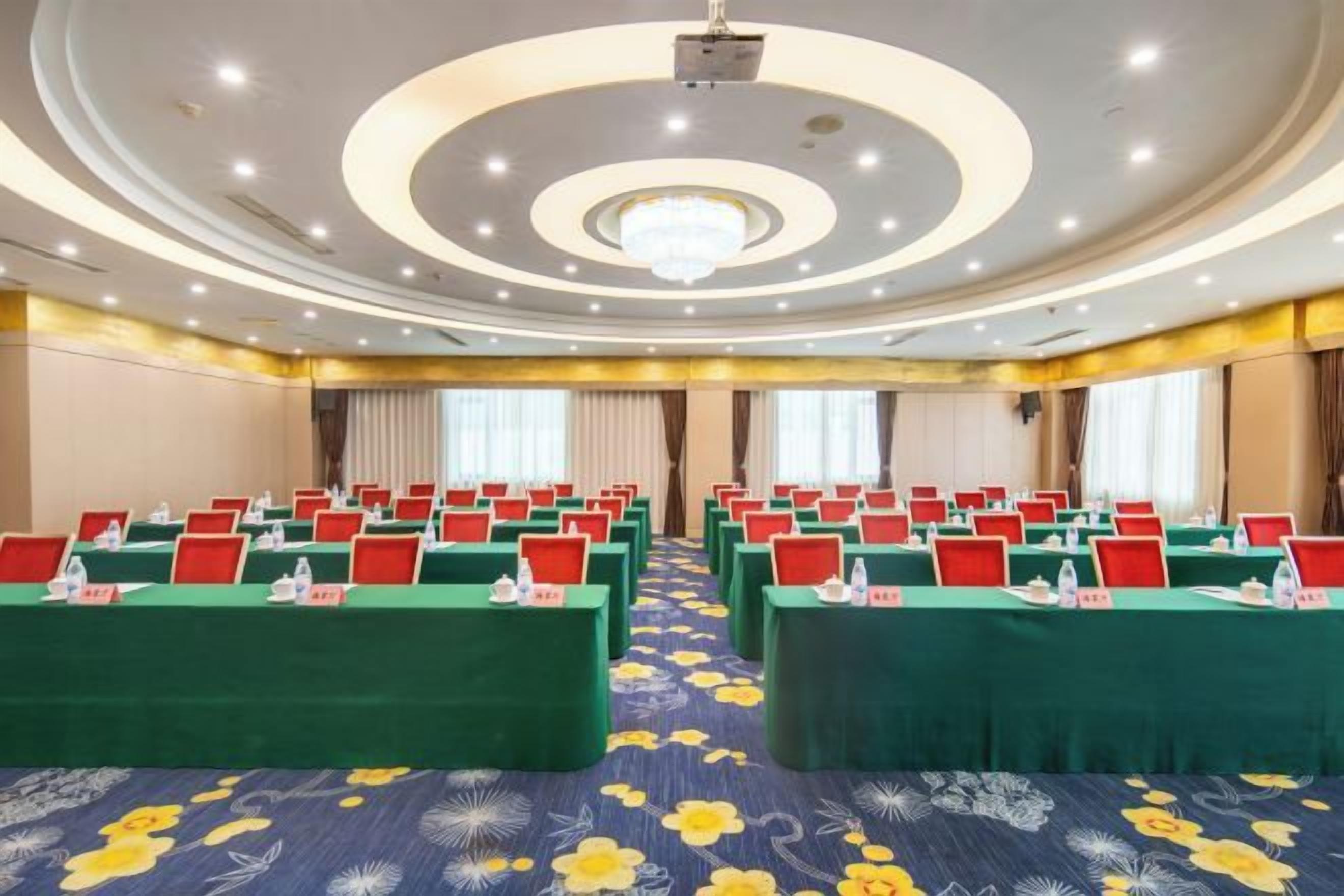 A conference room with multiple tables, each with nameplates and water bottles.