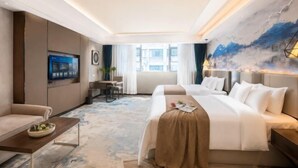 A hotel room with a bed, a desk, a television, and a large window. - Jinxiu Xiangjiang Hotel (Foshan Jinsha) (Foshan)