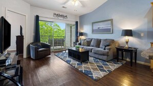A living room with a sofa, coffee table, and a TV. - Holiday Ridge Retreat 10 - Holiday Hills Branson - Golf Resort - Outdoor Pools (Branson)