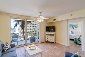 Relax in this open-plan living area with a sofa, armchair, and flat-screen TV.