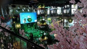 A multi-level indoor space with various plants and a large screen. - Tiancheng Plaza Hotel (Neijiang)