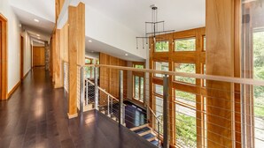 A spacious hallway with wooden paneling and large windows. - Luxurious Modern Home Steps to Gondola & Village (Stratton)
