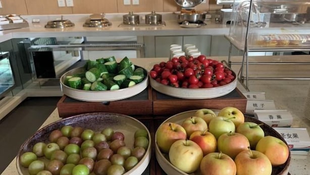 Buffet amb diverses fruites, com ara pomes, cireres i cogombres.