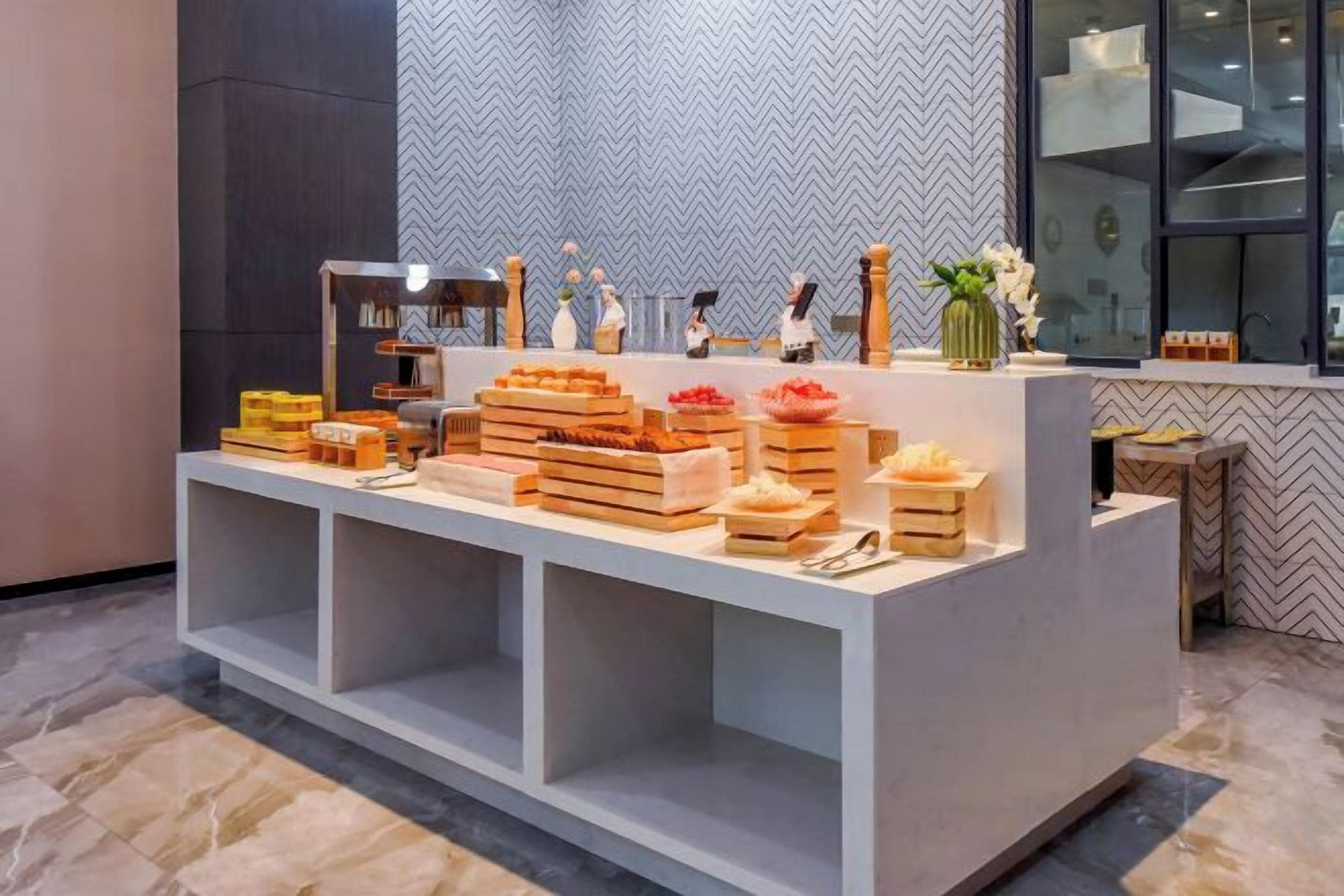 A buffet setup with various food items and decorative elements.