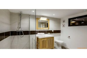 Shower, hair dryer, towels, toilet paper