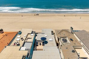 A beachside hotel with rooftop terraces, a pool, and ocean views.