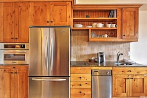 Enjoy cooking in this well-equipped kitchen with a refrigerator, oven, and dishwasher.