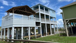 A two-story building with a balcony and a covered area.
