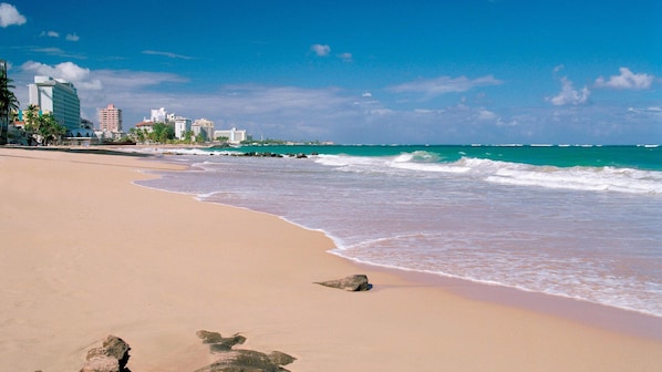 Una playa cerca, sillas reclinables de playa, toallas de playa
