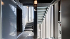 A modern building with a staircase, a number '6F' sign, and a metal railing. - FL Hotel Asakusa (Tokyo)