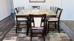 A dining area with a rectangular table, six chairs, and a world map on the wall. - Archie's Place: 20 minute's from the Great Sand Dunes (Blanca)