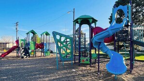 A playground with various play structures including slides and climbing areas. - Archie's Place: 20 minute's from the Great Sand Dunes (Blanca)