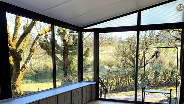 A room with a bed, large windows, and a view of trees. - Listed country house in Périgord between Sarlat, Lascaux and Rocamadour (Salignac-Eyvigues)