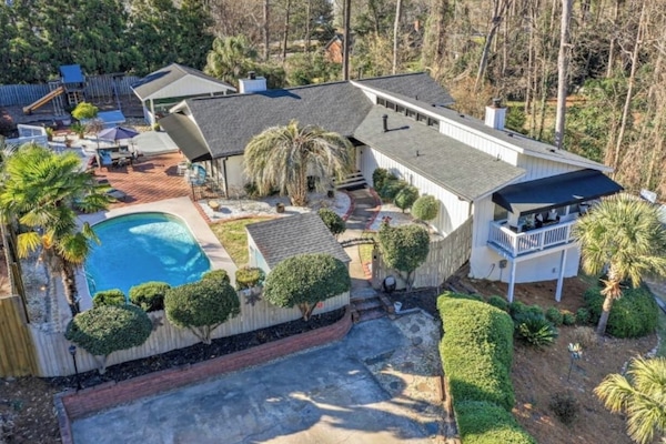Aerial photo of the rental which includes fun for both kids and adults: a heated pool, Aria Hot tub, and expansive playground.