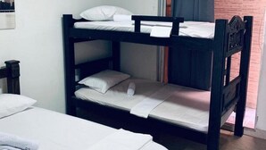 A bunk bed room with a white mattress, a small bedside table, and an air conditioning unit on the wall. - 2CL1-J Apartamento en el Centro Histórico (Cartagena)
