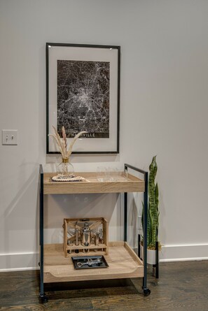 Experience a serene retreat with a cityscape view, a potted plant, and a decorative vase.