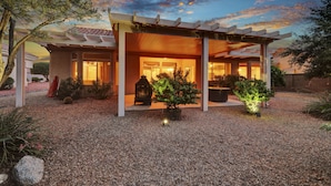 A modern house with a covered patio, a well-maintained garden, and a cozy interior.