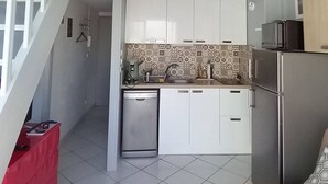 A kitchen with white cabinets, a dishwasher, and a microwave.