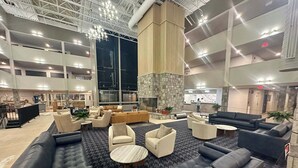 A spacious lobby with multiple seating areas, a stone fireplace, and a high ceiling with exposed beams. - Mountain Lodge - Ski In/Out - 2 Queen Bedrooms + 2 Bunk Beds - Closest To Lifts (Snowshoe)