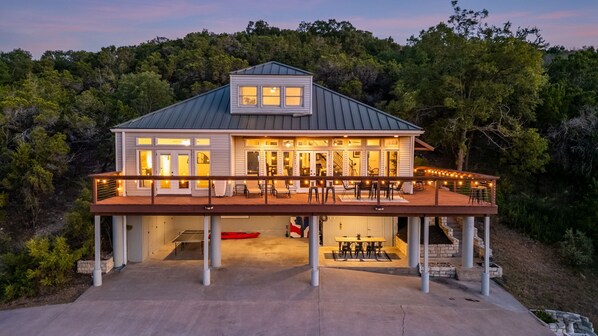 A two-story house with a covered patio and a garage.