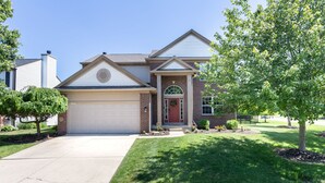 A two-story house with a garage, a front porch, and a well-maintained lawn. - Westfield Gem! 7 Mins to Grand Park + Movie Room! (Westfield)