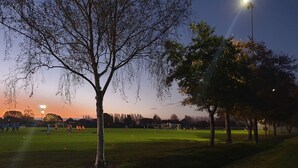 A park with a soccer field, trees, and street lamps. - Chic Private Studio Close to Airport, Bus & Shops - Breakfast included (Christchurch)