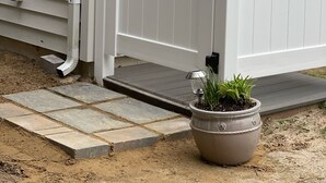 A white gate with a metal handle and a small potted plant beside it. - Broadkill Beach House- Dog Friendly! Sleeps 13 (Milton)