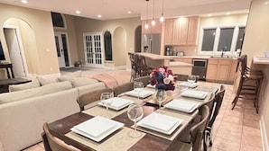 A dining area with a wooden table set for six, surrounded by chairs. - Play @ The Hideaway - hot tub, sauna, gymnasium (Three Oaks)