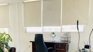 A room with a bed, a desk, a chair, a small round mirror, a potted plant, and a treadmill. - Romantic Zone 5 Blocks From the Beach (Puerto Vallarta)