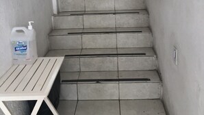 A narrow stairway with a white bench and a potted plant at the top. - Romantic Zone 5 Blocks From the Beach (Puerto Vallarta)
