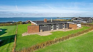 A modern house with a brick exterior, a flat roof, and a small front yard. - Beautiful home in Knebel with WiFi (Knebel)