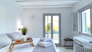 A modern bedroom with a bed, bedside table, and a view through a large window.