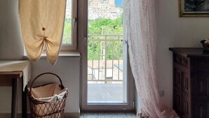 A room with a view of a cityscape through a balcony door. -  Large ecohome a Tricarico near Matera, with kitchen,parking, green (Tricarico)