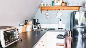 A compact kitchen with a toaster, sink, and a refrigerator. - Rest & Recharge, A-frame Cabin on Winery Grounds (Colonial Beach)