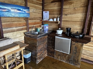Enjoy cooking in this cozy kitchen with a sink, refrigerator, coffee maker, and toaster.