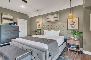 A modern bedroom with a large bed, a dresser, a bench, and two nightstands with decorative items. - Near State Park Marina with Game Room, Private Hot Tub, Golf Cart, Community Pools & Free Tickets! (Hollister)