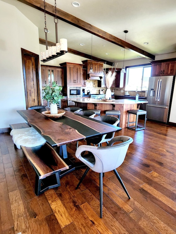 A modern kitchen with wooden cabinetry, a large island, and stainless steel appliances.